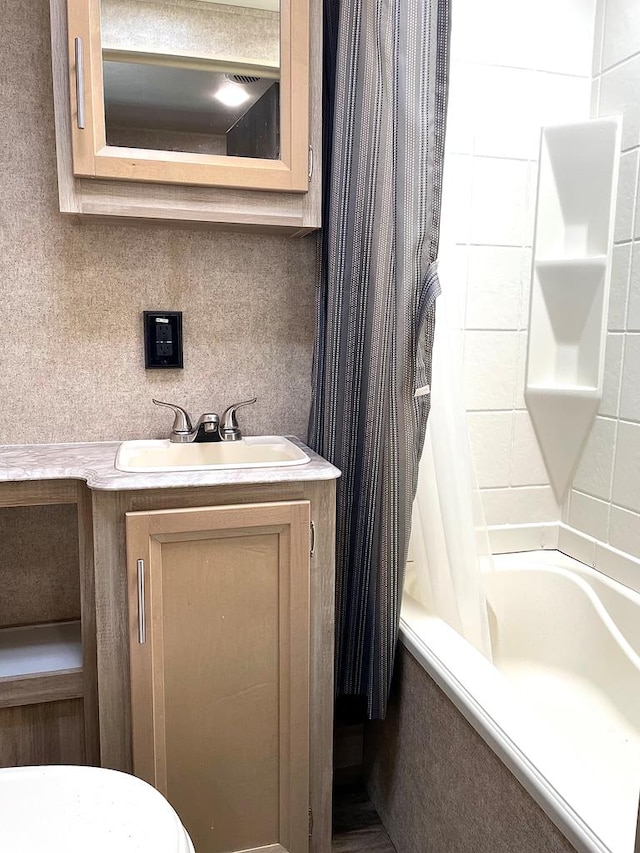 bathroom with shower / bath combination with curtain and vanity