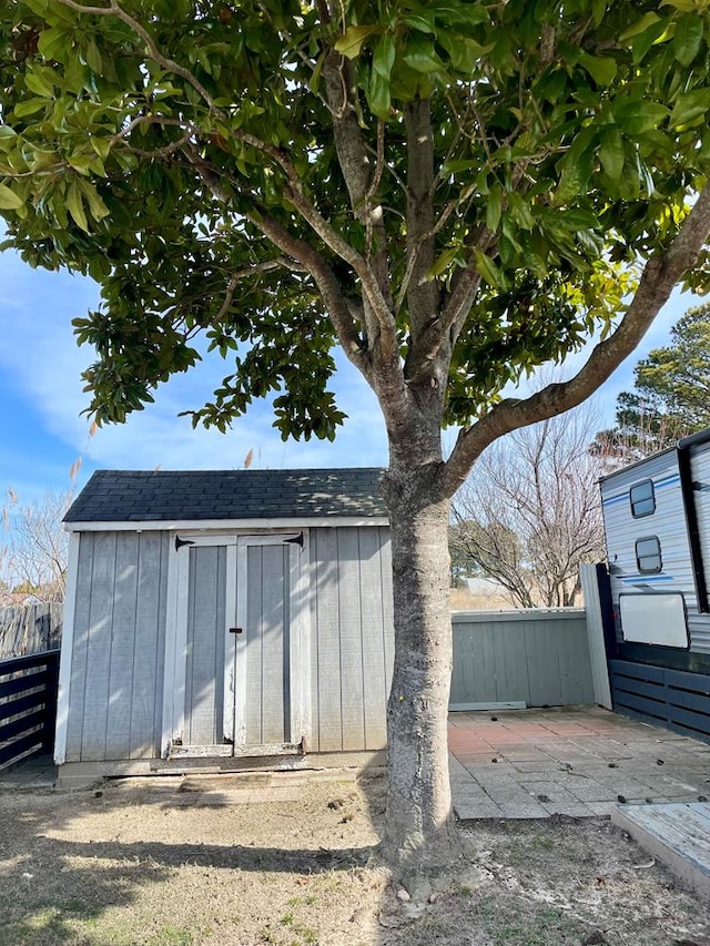 view of shed with fence