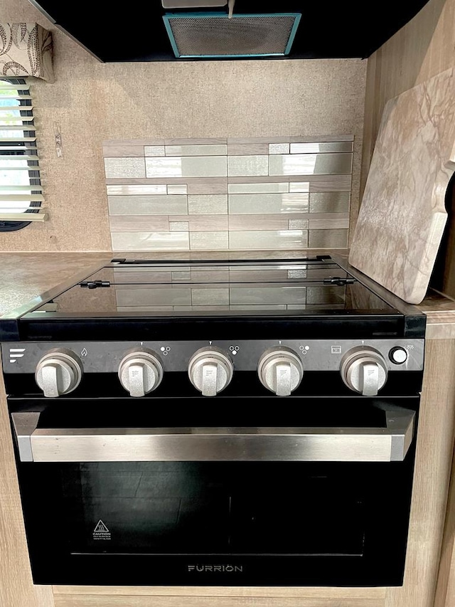 details featuring light countertops and oven