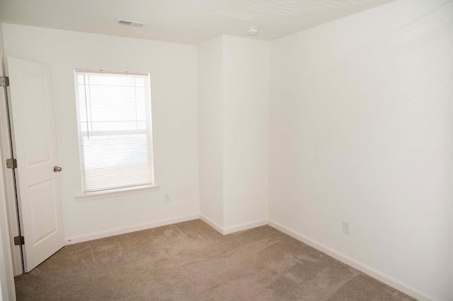 unfurnished room with light carpet