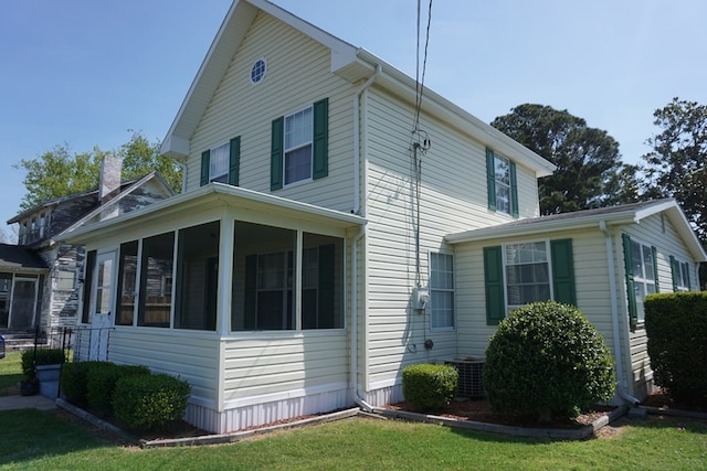 view of side of home with a sunroom