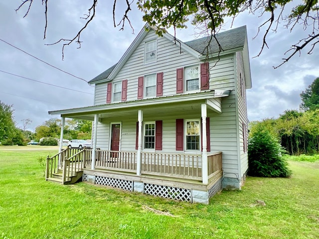 farmhouse inspired home with a porch and a front lawn