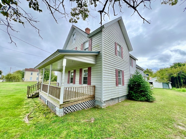 view of property exterior featuring a yard, covered porch, and a chimney
