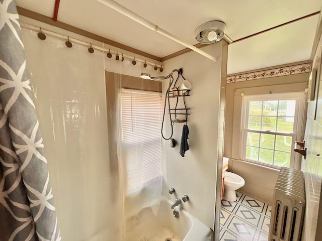 bathroom featuring toilet, tile patterned floors, and shower / tub combo