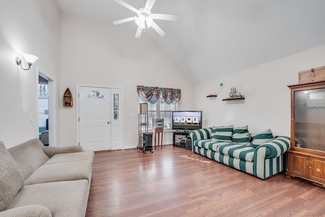 living area featuring ceiling fan, a wealth of natural light, and wood finished floors