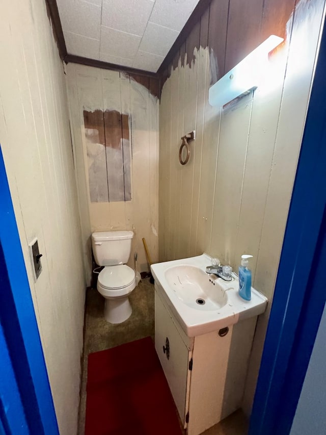 6136 Maddox Blvd, Chincoteague, VA 23336 - half bath featuring toilet, wood walls, and vanity