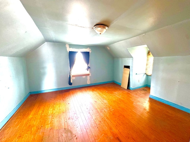 6136 Maddox Blvd, Chincoteague, VA 23336 - additional living space featuring baseboards, vaulted ceiling, and hardwood / wood-style flooring
