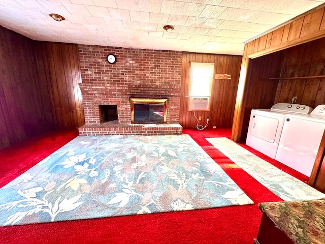6136 Maddox Blvd, Chincoteague, VA 23336 - laundry area featuring washing machine and dryer, carpet, wood walls, a brick fireplace, and laundry area