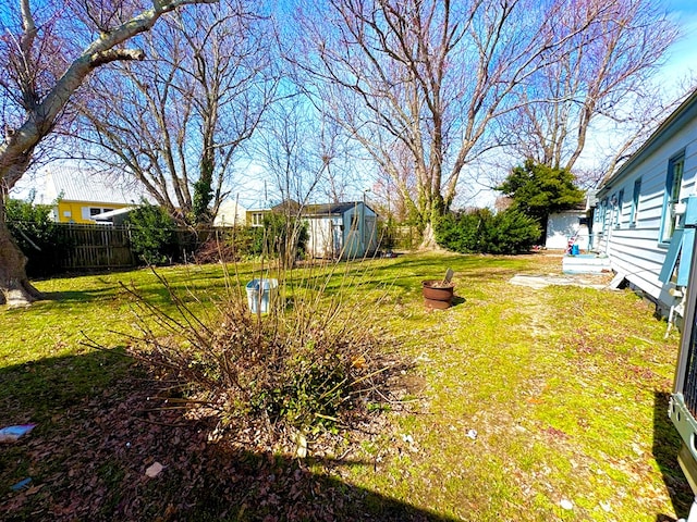 6136 Maddox Blvd, Chincoteague, VA 23336 - view of yard with an outbuilding, fence, and a shed