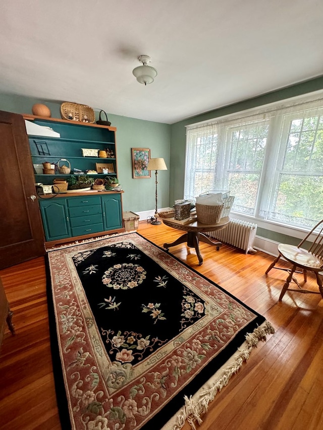 interior space with radiator heating unit and hardwood / wood-style flooring