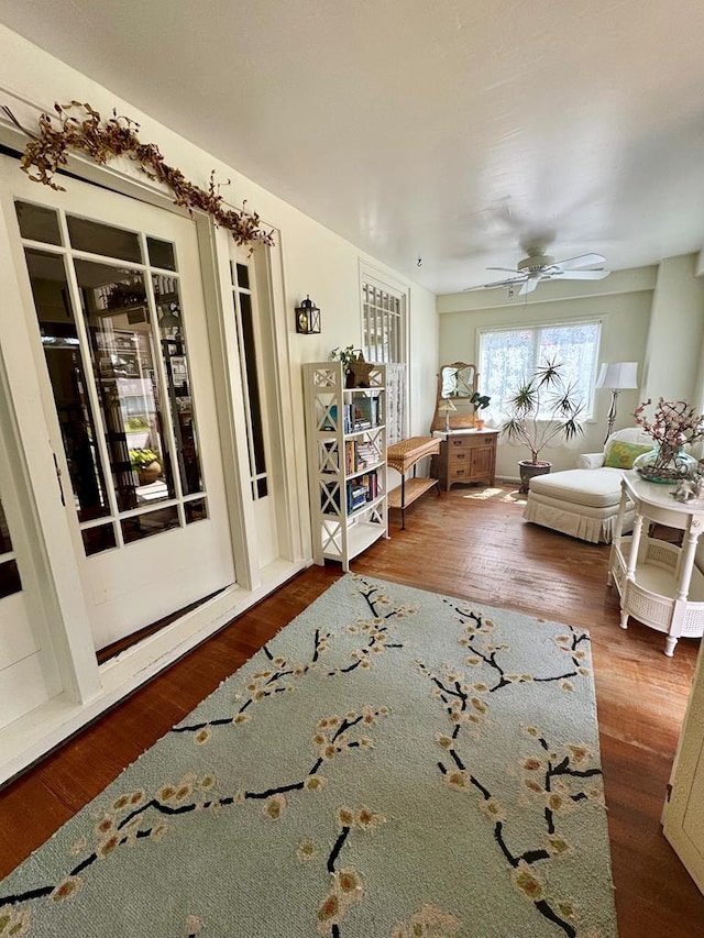 unfurnished living room with dark hardwood / wood-style floors and ceiling fan