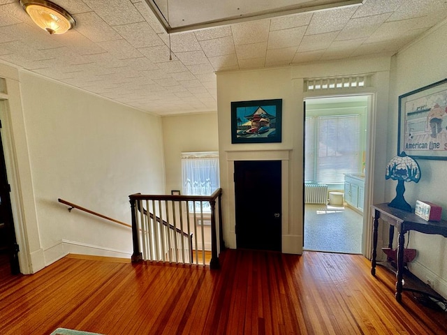 foyer with wood-type flooring and radiator