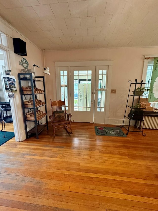 sitting room featuring a healthy amount of sunlight, crown molding, and light hardwood / wood-style flooring