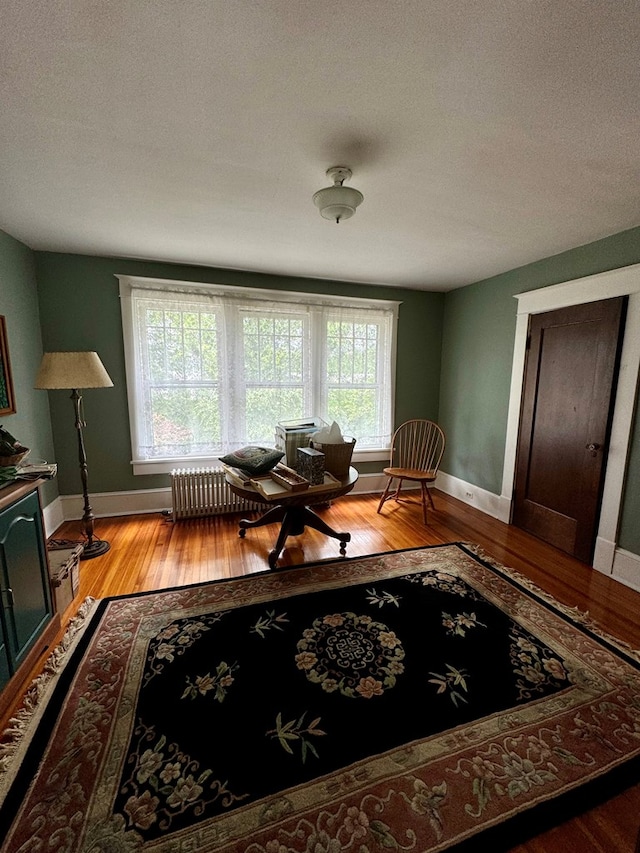 sitting room with wood-type flooring and a textured ceiling