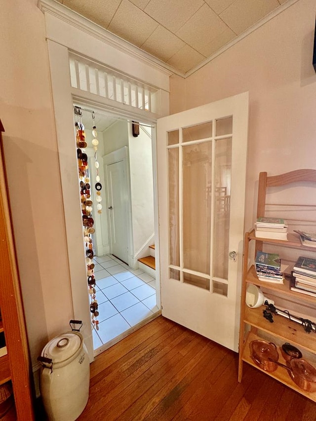 interior space with wood-type flooring and ornamental molding