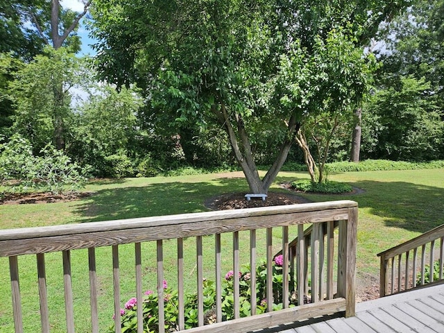 wooden terrace featuring a lawn