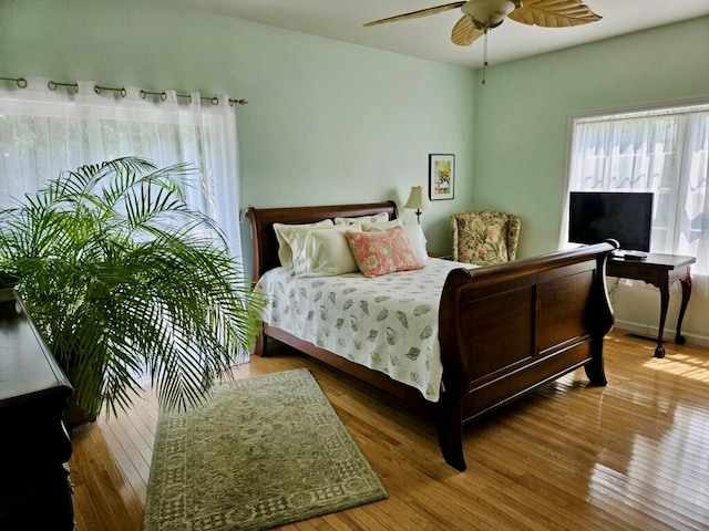 bedroom with wood-type flooring and ceiling fan