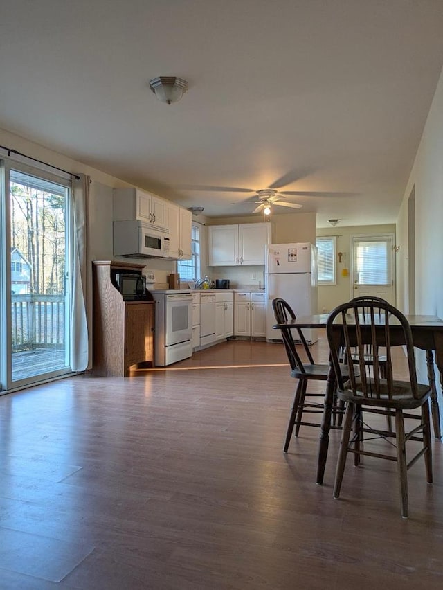 kitchen featuring ceiling fan, white appliances, dark hardwood / wood-style floors, and white cabinets