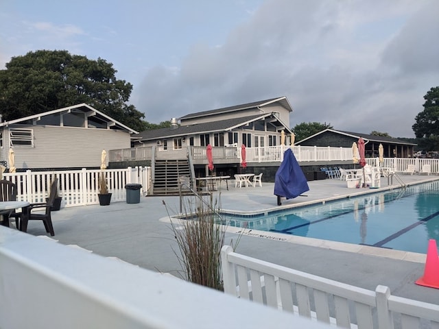 view of swimming pool featuring a deck and a patio area