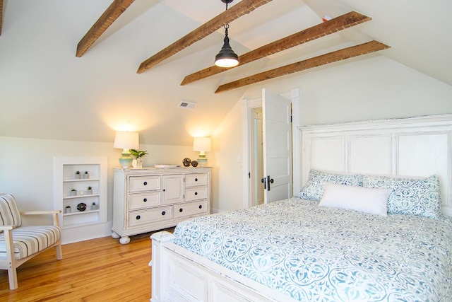 bedroom with lofted ceiling with beams and light hardwood / wood-style floors