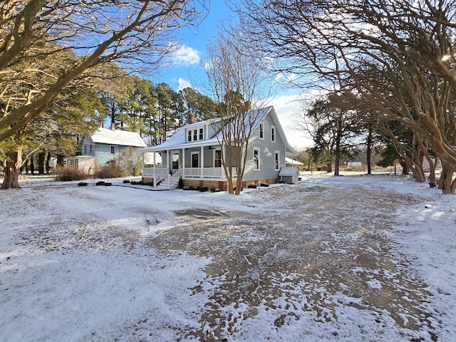 view of snow covered exterior with a porch