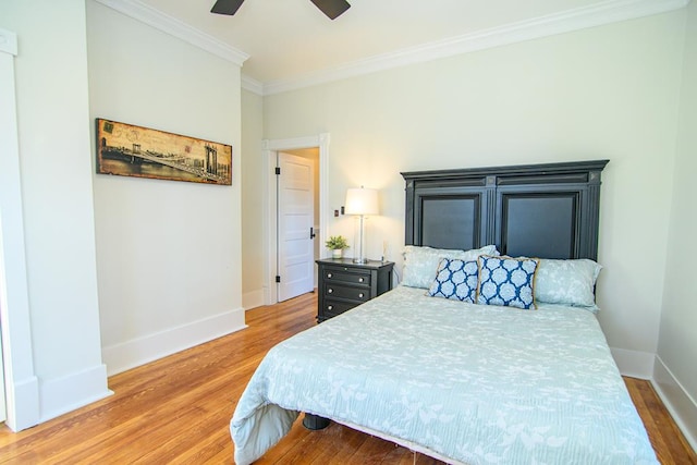 bedroom with hardwood / wood-style floors, ceiling fan, and ornamental molding