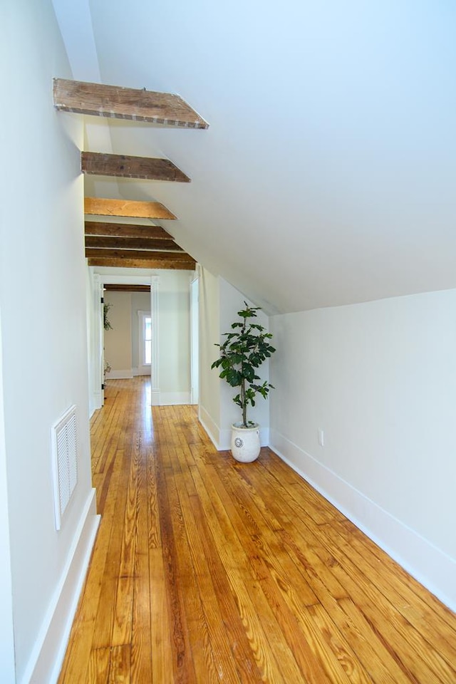 bonus room with vaulted ceiling with beams and hardwood / wood-style floors