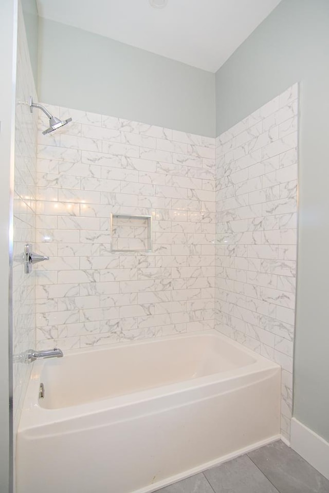 bathroom featuring tile patterned floors and  shower combination