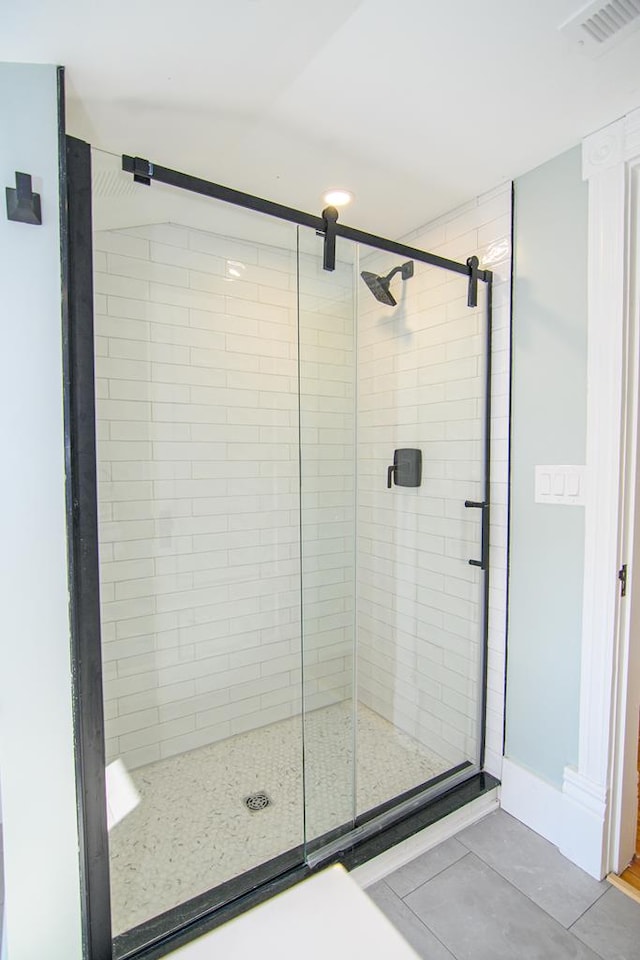 bathroom with a shower with door