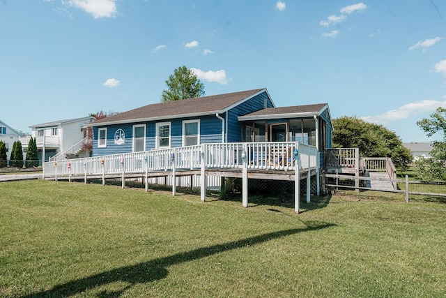 6345 Clark St, Chincoteague, VA 23336 - back of property featuring a deck, a lawn, and roof with shingles