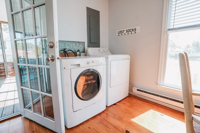 6345 Clark St, Chincoteague, VA 23336 - laundry room featuring electric panel, washing machine and dryer, a baseboard heating unit, and plenty of natural light