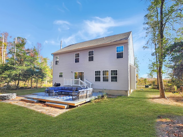 back of property featuring outdoor lounge area, a deck, and a lawn