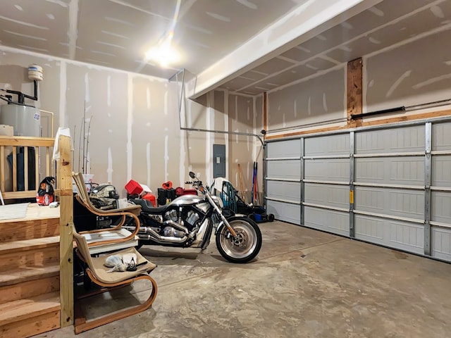 garage featuring electric panel and water heater