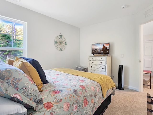 bedroom with light colored carpet