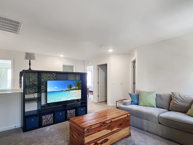 living room with light carpet and a healthy amount of sunlight