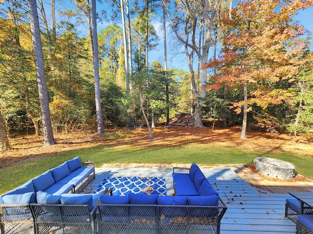 exterior space with outdoor lounge area, a deck, and a lawn