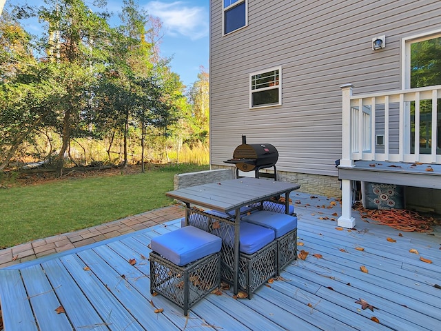 wooden deck with a yard and area for grilling