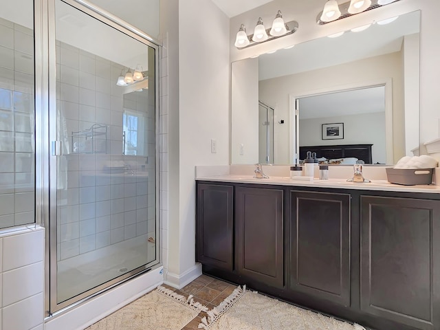 bathroom with vanity and a shower with door