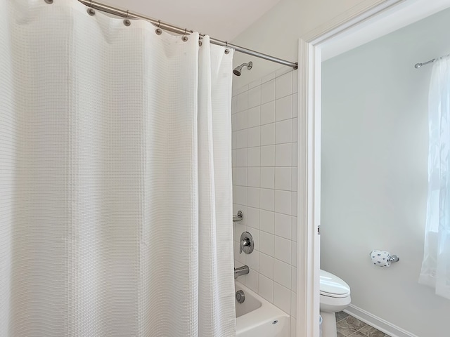 bathroom with shower / bath combination with curtain and toilet