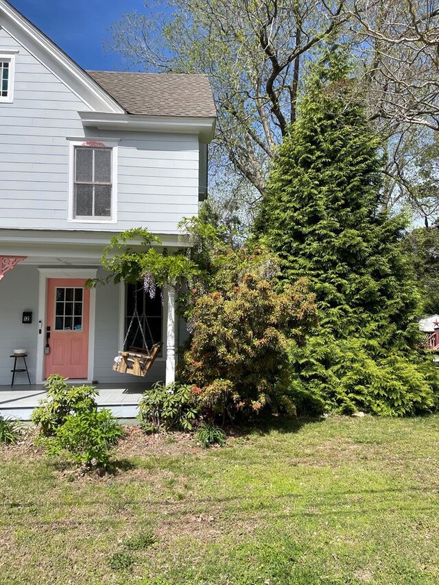 12 Justis St, Onancock, VA 23417 - view of front of property with a front yard, a shingled roof, and a porch