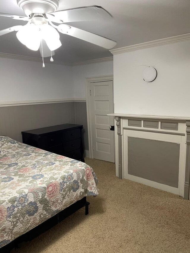 12 Justis St, Onancock, VA 23417 - bedroom with light carpet, ornamental molding, wainscoting, and a ceiling fan