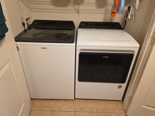 12 Justis St, Onancock, VA 23417 - washroom with separate washer and dryer and light tile patterned floors