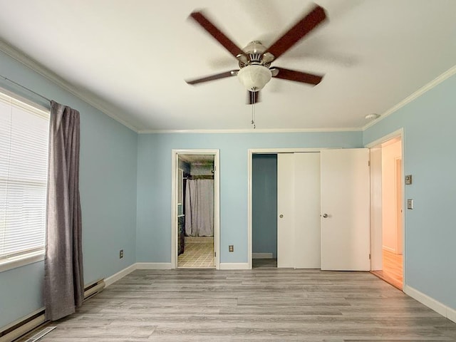 unfurnished bedroom with a closet, light wood finished floors, baseboard heating, baseboards, and ornamental molding