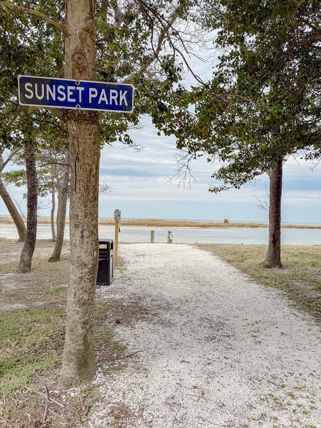view of home's community featuring driveway and a water view