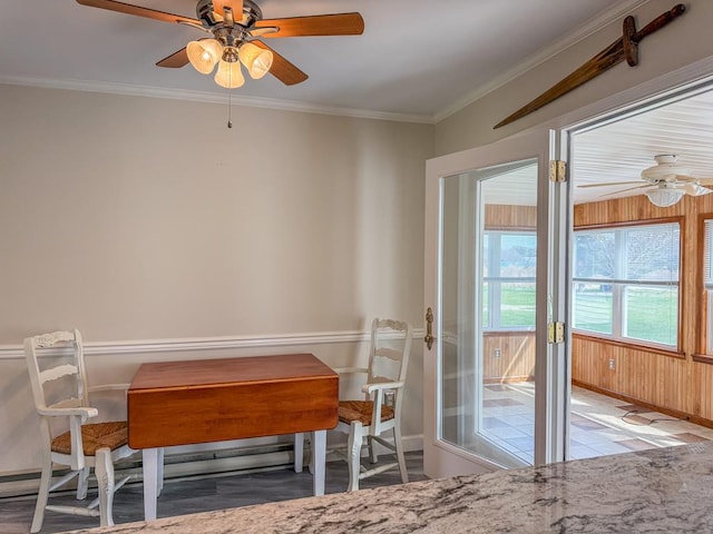 dining room with baseboards, ornamental molding, and ceiling fan