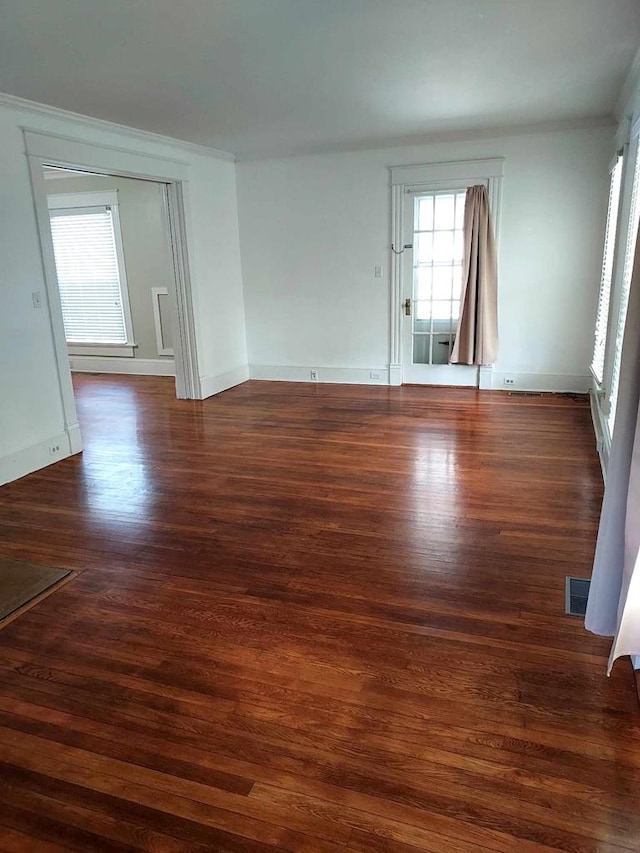 unfurnished room with dark hardwood / wood-style floors