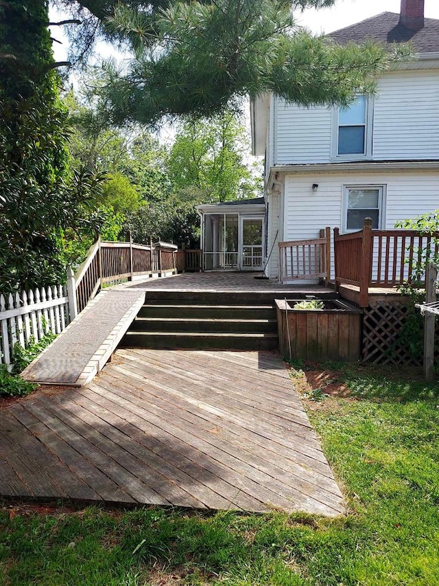 wooden deck featuring a sunroom