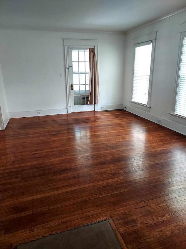 empty room with dark wood-type flooring