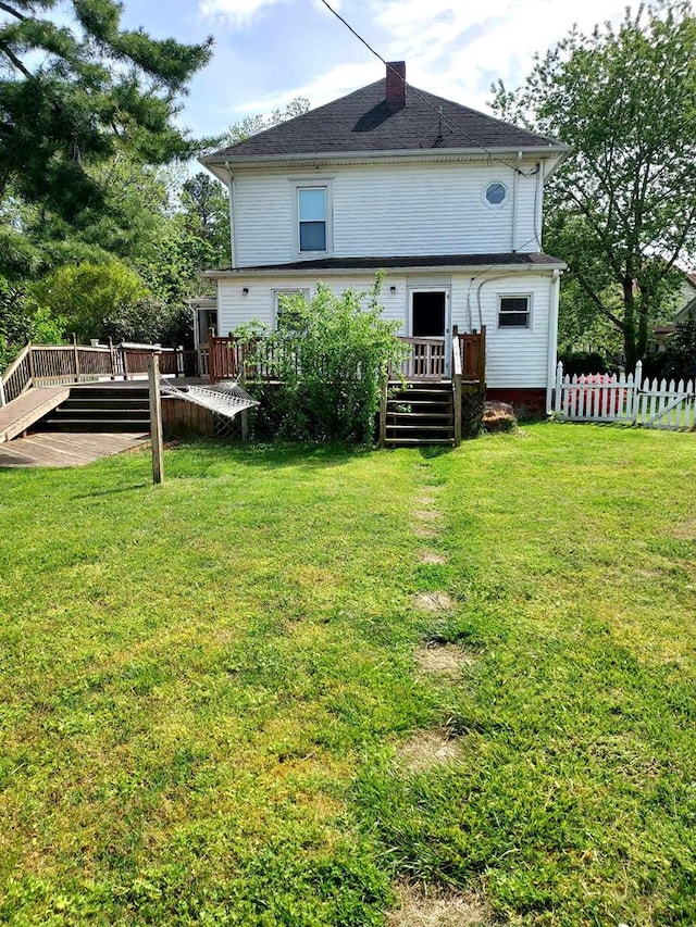 back of house featuring a yard and a wooden deck