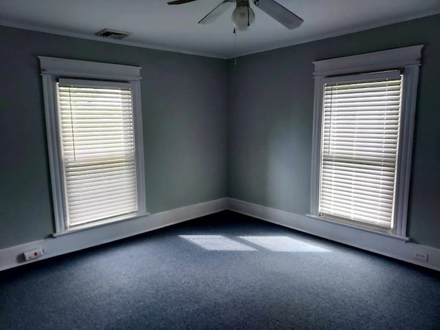 carpeted empty room featuring ceiling fan and a healthy amount of sunlight